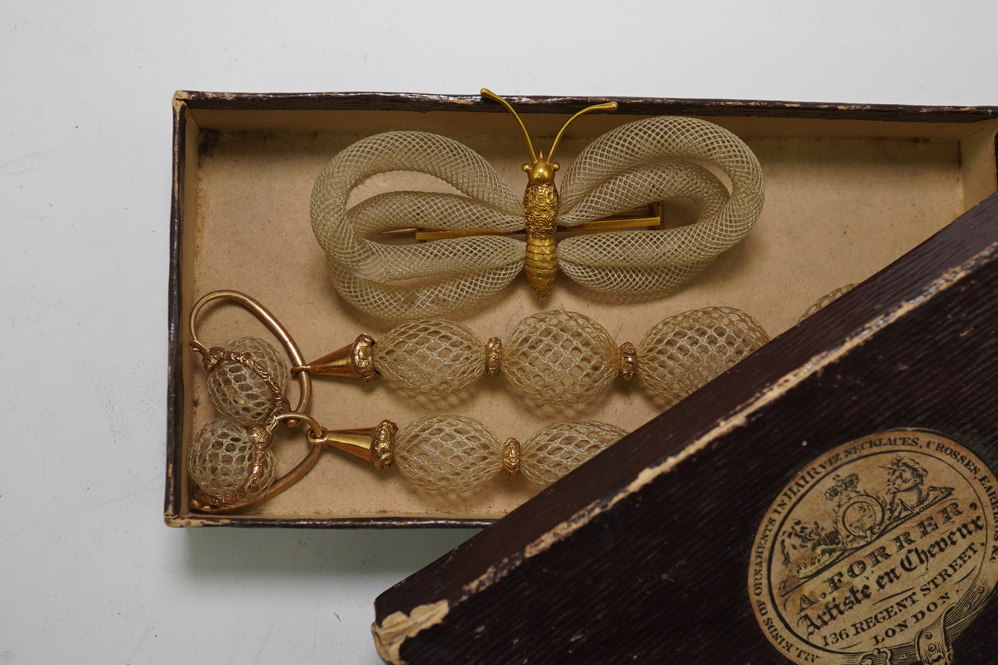 Antoni Forrer (1802/3-1889), 'Artiste en Cheveux', 136 Regent Street, London. A pair of gold mounted hairwork drop earrings and a butterfly brooch